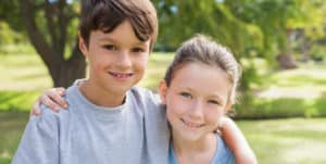 Boy and girl siblings smiling at camera