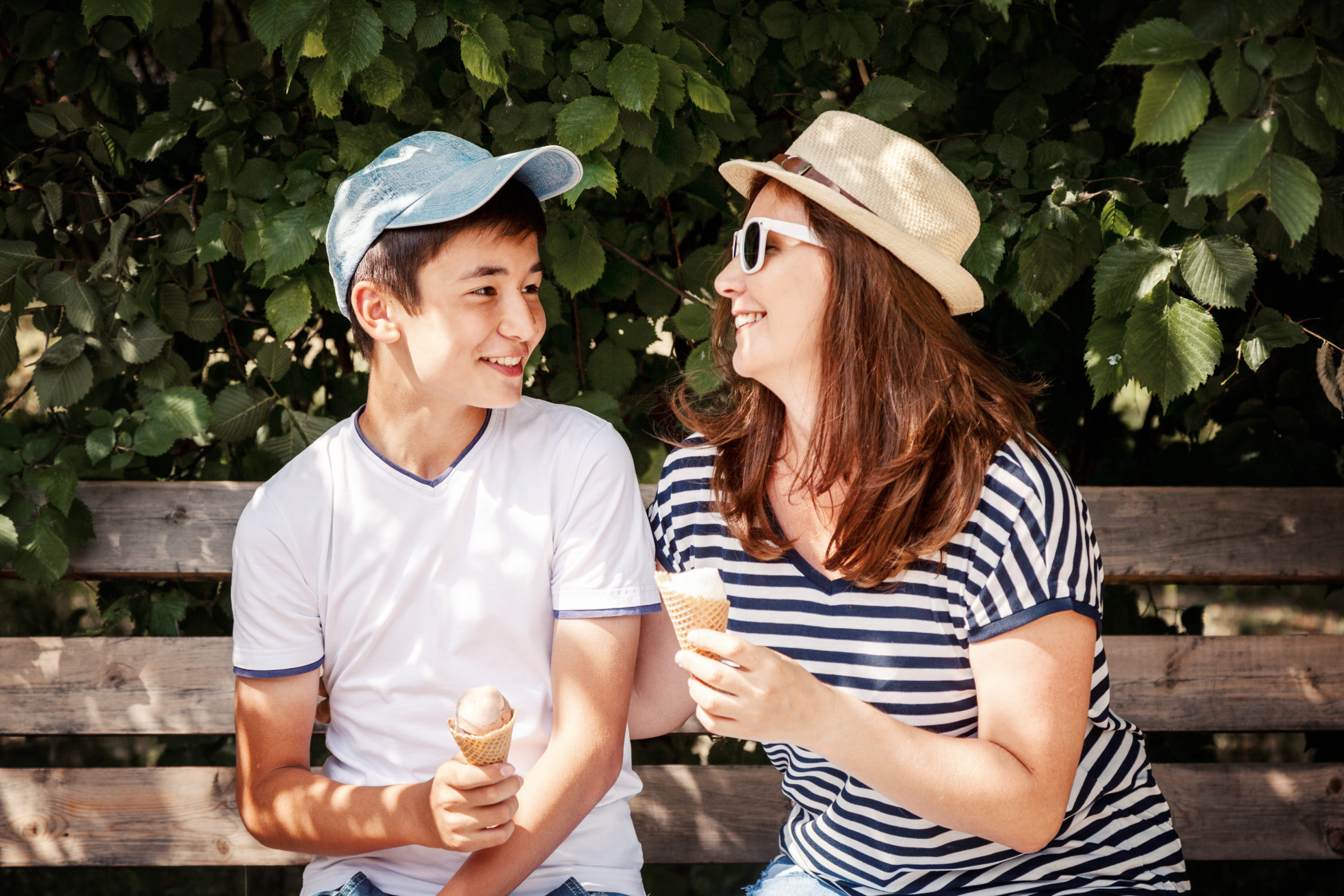 Woman and boy eating ice cream on a bench
