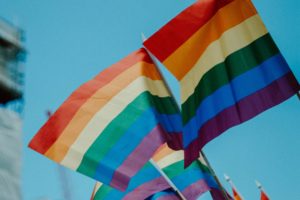 Several Pride flags waving against sky
