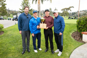 Team of smiling golf champions at Fostering Hope Golf Classic tournament