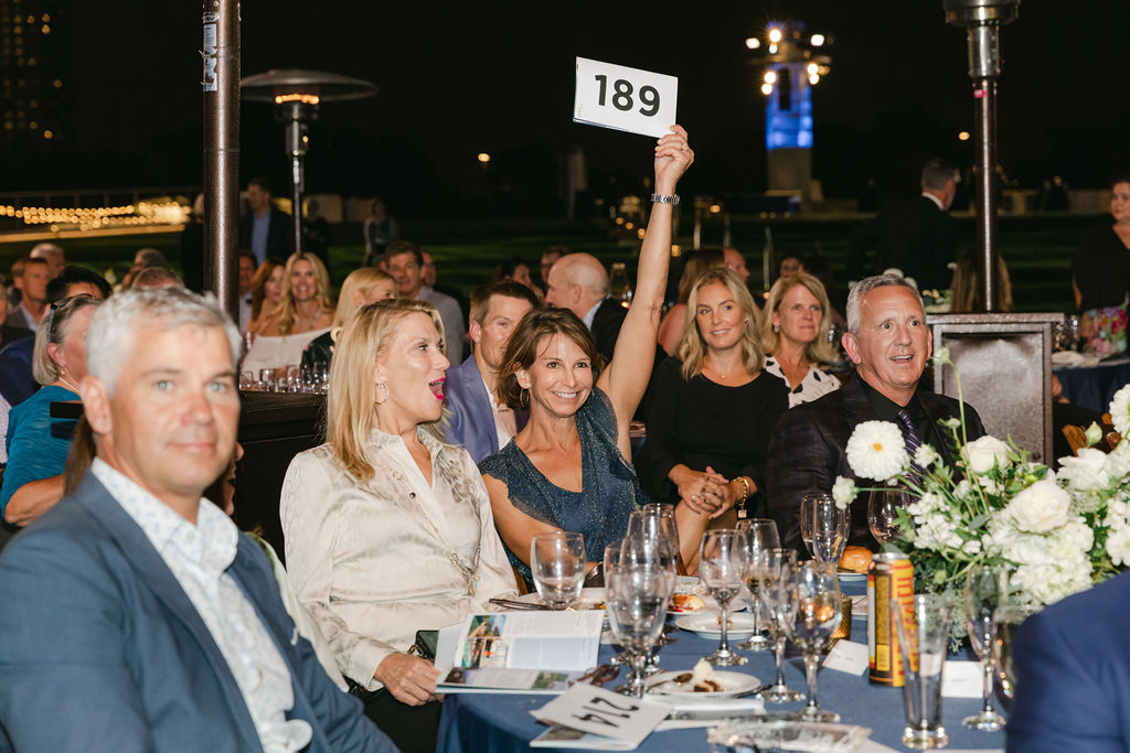 Lany Zikakis bidding on live auction at Starry Starry Night gala