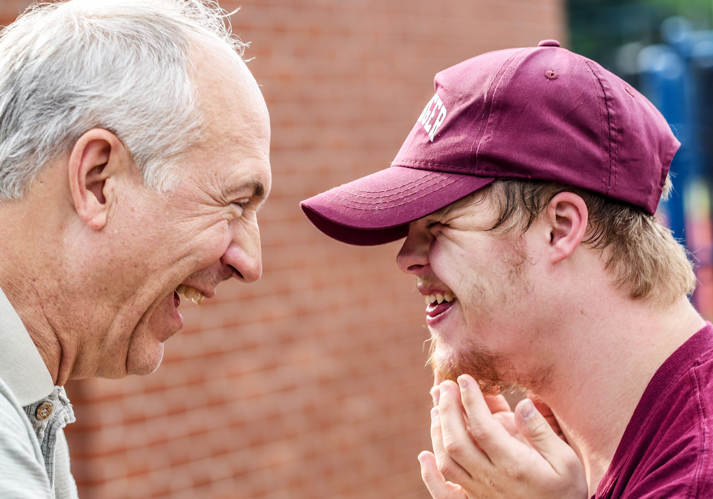 boy-with-down-syndrome-smiling-at-man